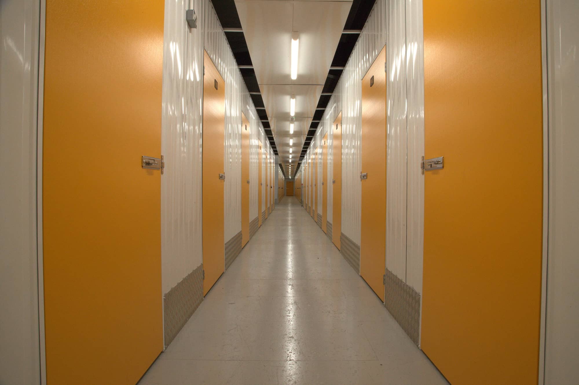 Corridor of orange self storage units