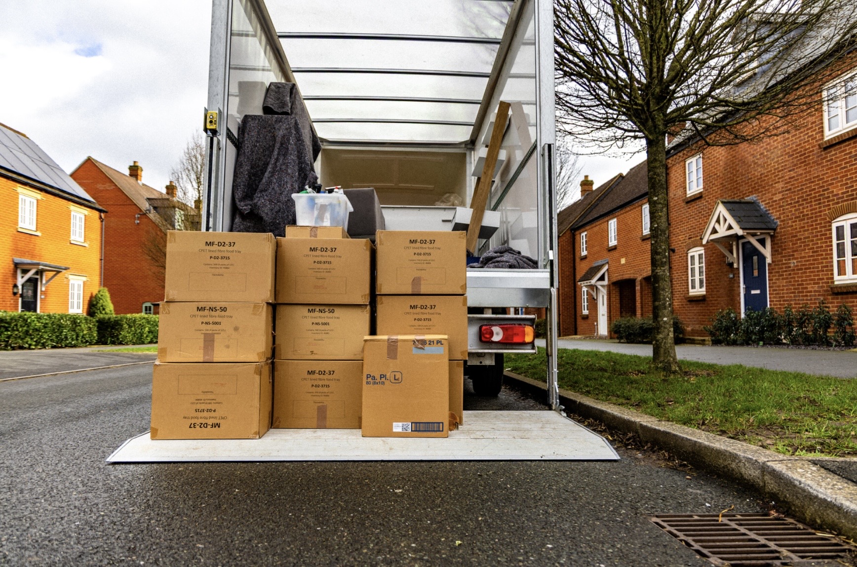 Boxes stacked on the tail lift of a removal van
