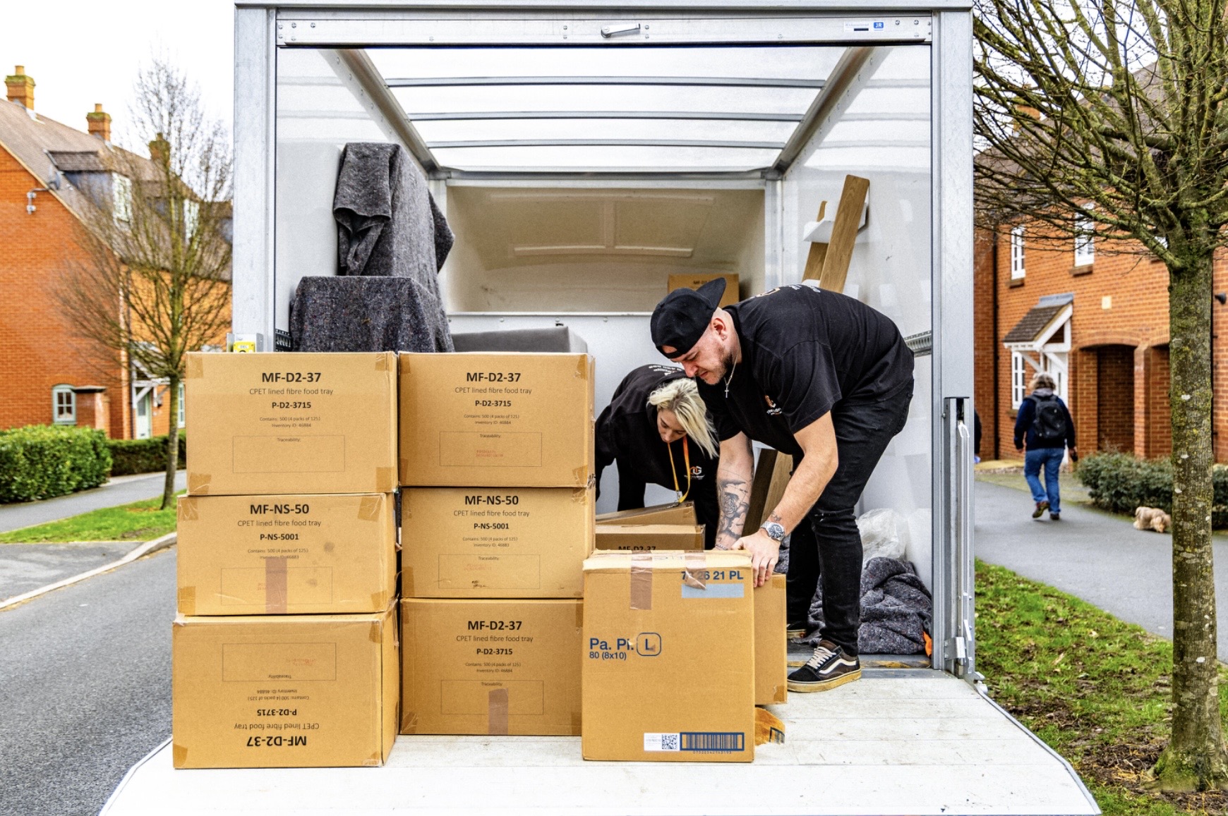 Mover unloading packed boxes from a van